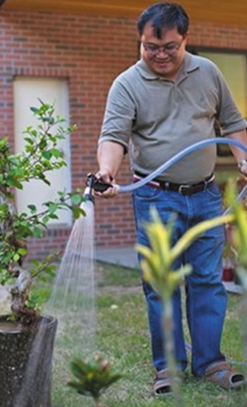 Fr. Jude waters the garden